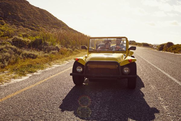 Young couple on a road trip in beach buggy